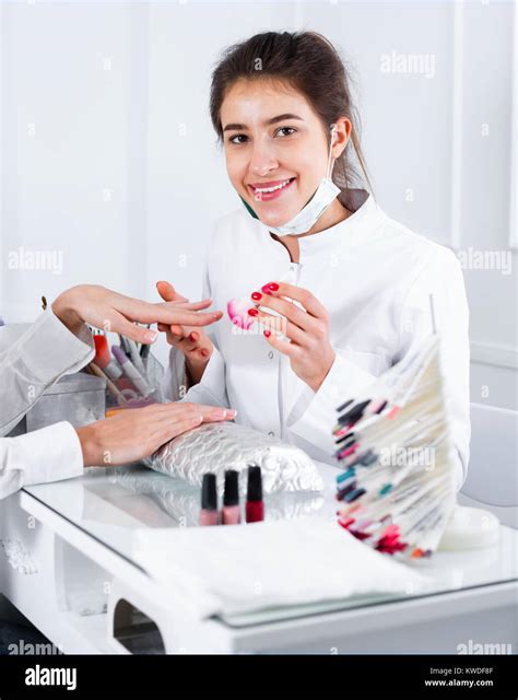 Young Pleasant Woman Doing Manicure In Nail Salon Stock Photo Alamy