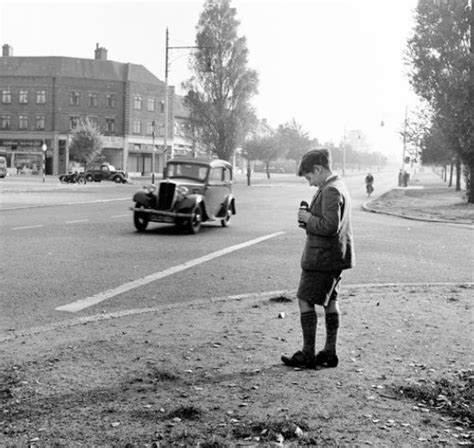 1950s A Schoolboy Taking Pictures Of Moving Cars With His Kodak