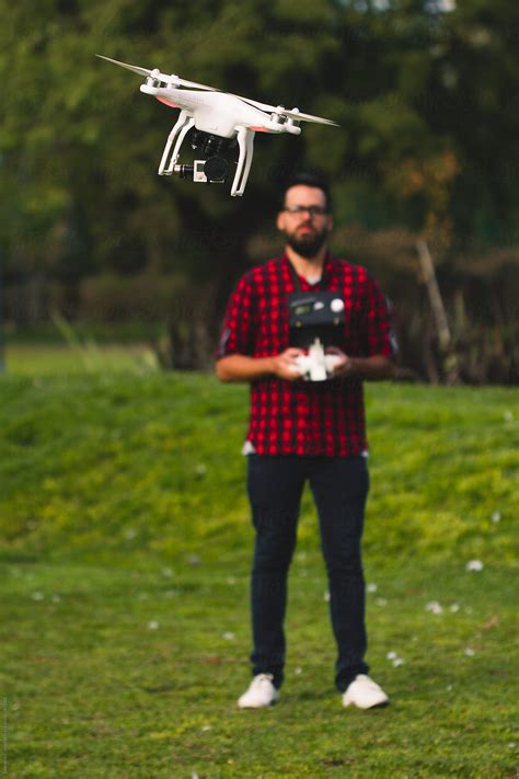 "Man Flying Drone" by Stocksy Contributor "Ohlamour Studio" - Stocksy