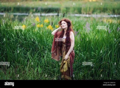 Portrait Of A Beautiful Mature Woman Dressed In A Nymph Style Dress Woman With Long Red Hair On