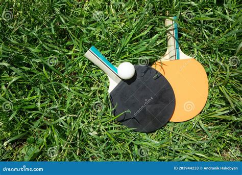 Tennis Ball And Racket On The Green Grass Background Stock Image