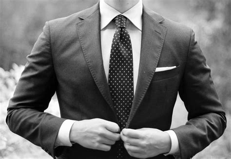 Download Stylish Businessman in Polished Suit and Polka Dots Tie Wallpaper | Wallpapers.com