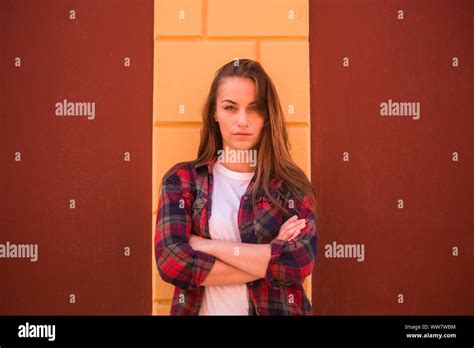 Angry Babe Looking At You With Blue Eyes Red Shirt Hipster Clothes And Yellow Wall On The