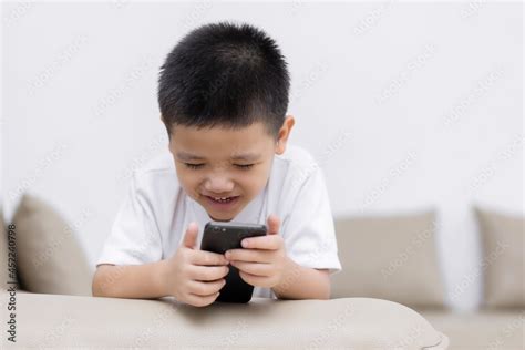 Little boy having fun playing game on mobile phone, Preschool kid ...