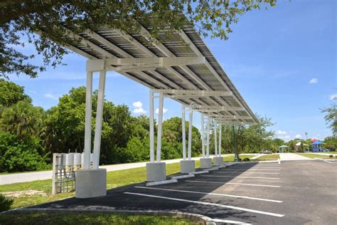 Solar Panels Installed As Shade Roof Over Parking Lot For Parked