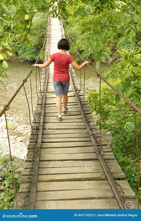 Girl Walking On A Wooden Bridge Over A River Stock Photo Image 44713323