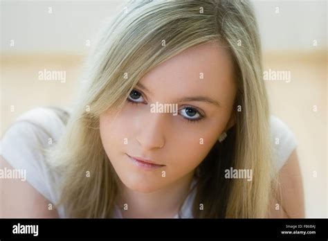 Head And Shoulder Shot Of Teenage 16 18 Years Old Woman Facing With Eye Contact Long Blonde