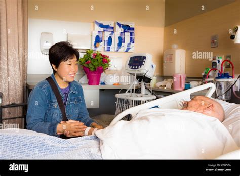 Hospital Patient and Visitor by Bedside Stock Photo - Alamy