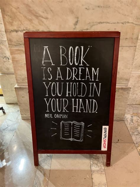 A Book Is A Dream You Hold In Your Hand Sign On The Floor Next To A