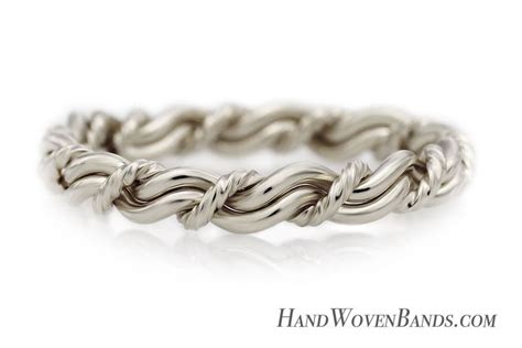 A Wedding Ring Made Out Of Twisted Silver Wire On A White Background