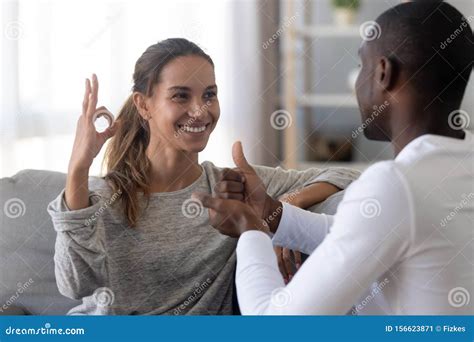 Happy Mixed Race Deaf Couple Using Sign Language For Communication