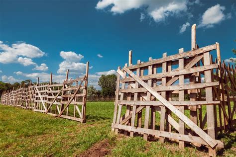 An Old Log Fence And A Blue Sky With Clouds Security And Fencing