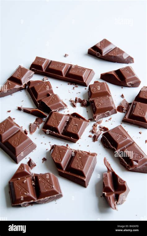 A Bar Of Cadburys Chocolate Broken Up Into Many Pieces Stock Photo Alamy