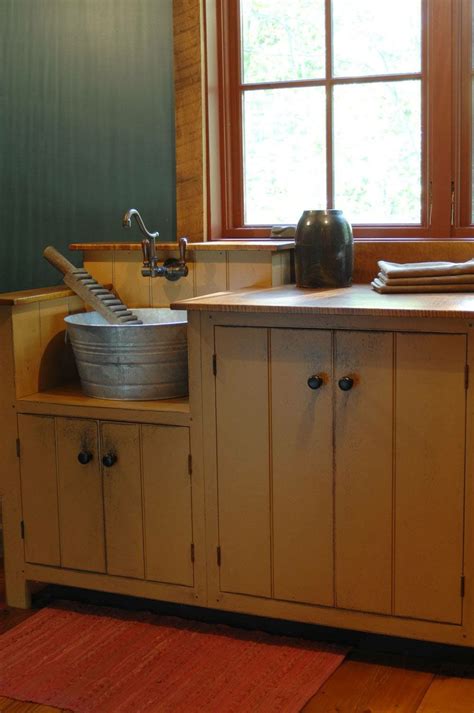 A Kitchen With Wooden Floors And Cabinets In Front Of A Window That Is