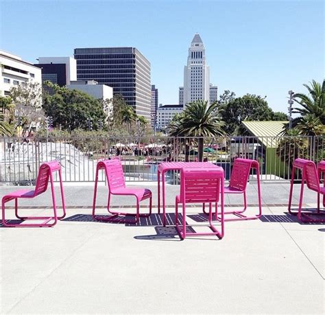 Pink Chairs And Tables In Front Of A City Skyline