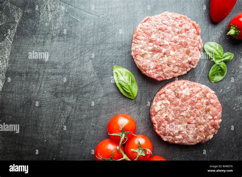 Fresh Raw Prime Black Angus Beef Burger Patties On Black Background