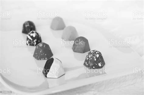 Black And White Image Of A Plate Of Fancy Chocolate Stock Photo