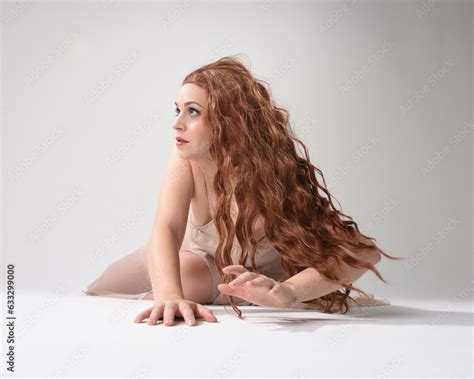 Full Length Portrait Of Beautiful Brunette Model Wearing A Pink Dress Graceful Sitting Pose