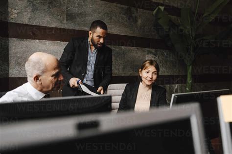 Male And Female Financial Advisors Discussing Together Over Computer