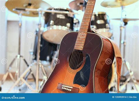 Acoustic Guitar Close Up with Drum Kit in Background Stock Photo - Image of percussion, musical ...