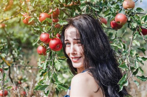 Sexy Brunette In A Wild Apple Orchard Portrait On The Background Apple