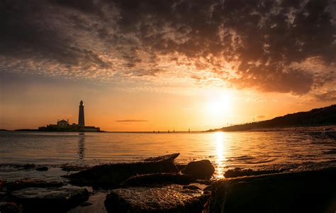 Beach Near Island With Lighthouse · Free Stock Photo