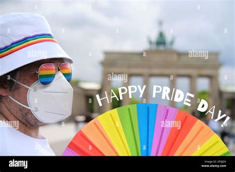 Mature Caucasian Lgbt Man In Berlin With Rainbow Fan And Ribbon On White Summer Hat Rainbow