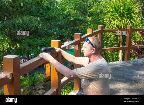 Mature Man Makes Amateur Video On Vacation In Tropical Jungle Stock Photo Alamy