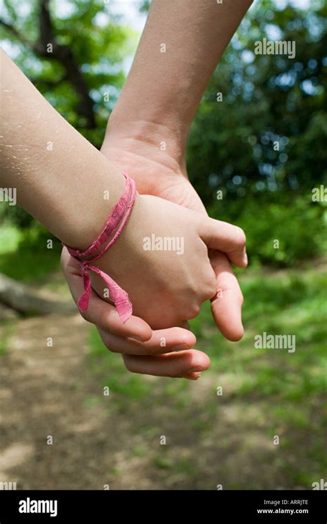 Teenage couple holding hands Stock Photo - Alamy