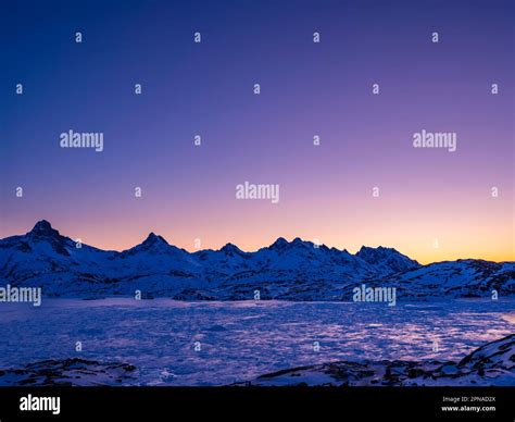 Snowy Mountains Above The Frozen Kong Oscar Fjord At Dawn Tasiilaq