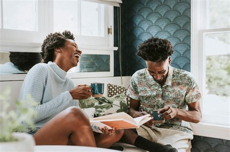 Premium Photo Happy Black Couple Reading A Book At Home