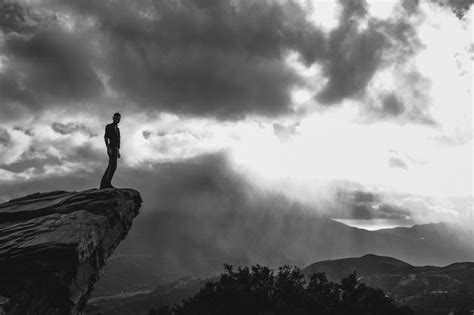 Premium Photo Silhouette Man Standing On Cliff Against Sky