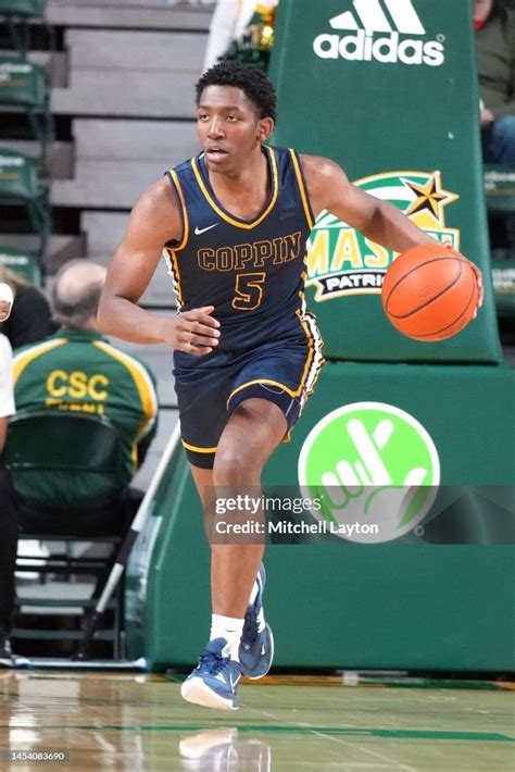 Devin Dinkins Of The George Mason Patriots Dribbles Up Court During A