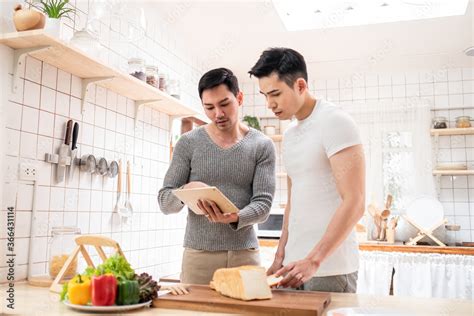 Lgbt Happy Asian Gay Couple Cooking Food Together In Kitchen Stock