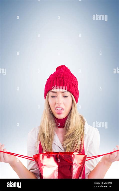 Disappointed Blonde Opening Gift Bag On Vignette Background Stock Photo