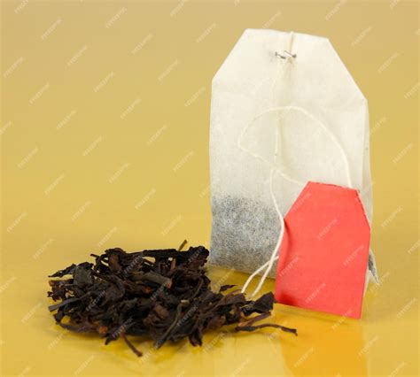 Premium Photo | Tea bag on yellow background
