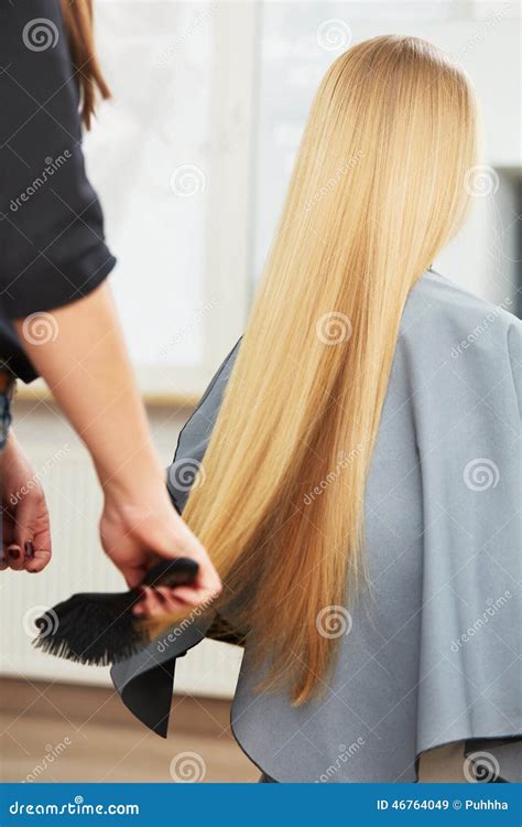 Blonde Hair Hairdresser Combing Long Blonde Hair In Salon Stock Image