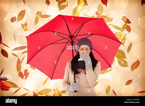 Composite Image Of Sick Brunette Blowing Her Nose While Holding An Umbrella Stock Photo Alamy