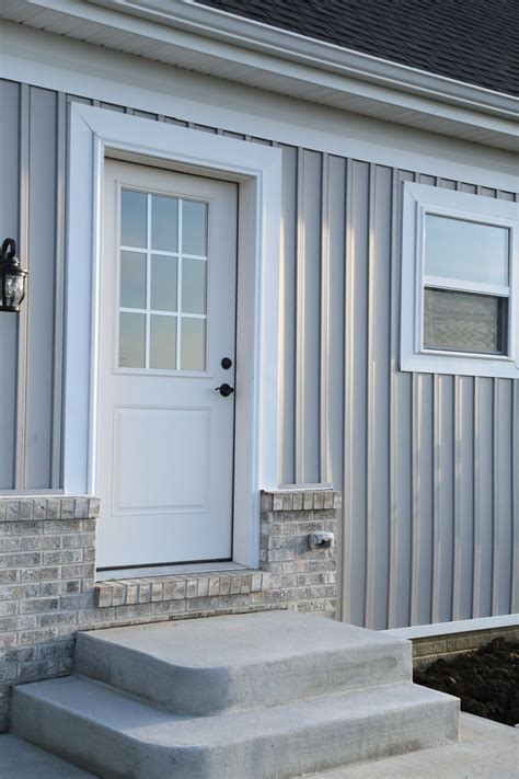 A House With White Doors And Steps Leading To The Front Door