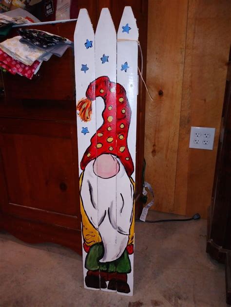 A Snowboard With An Image Of A Gnome On It S Face Is Standing In Front