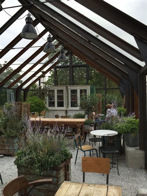 An Outdoor Dining Area With Tables And Chairs In The Center Surrounded