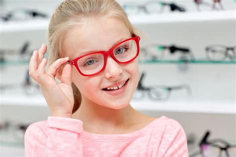 little girl in glasses at optics store - Magruder Eye Institute