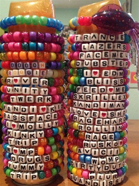 Two Stacks Of Colorful Bracelets Sitting On Top Of A Wooden Table Next