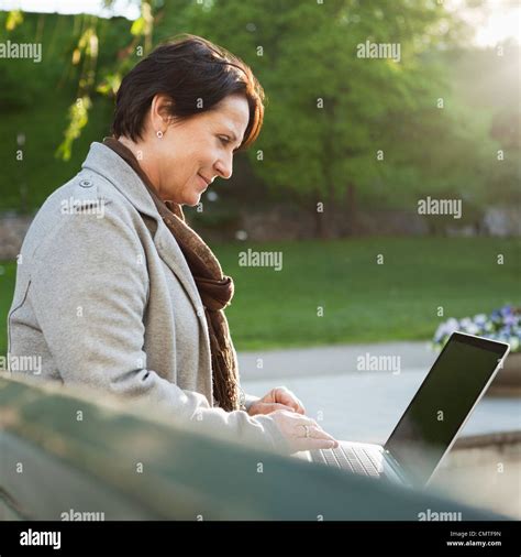 Smiling Mature Woman Using Laptop Stock Photo Alamy