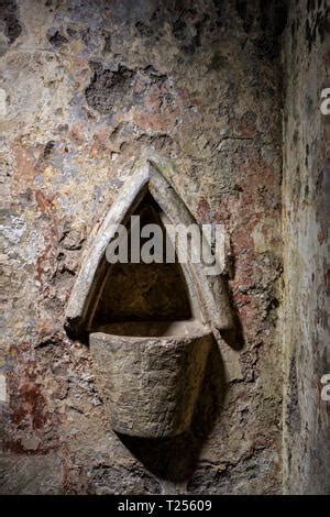 The Holy Water Stoup In The Ornate Gothic Cloister Arcade Arches Of The