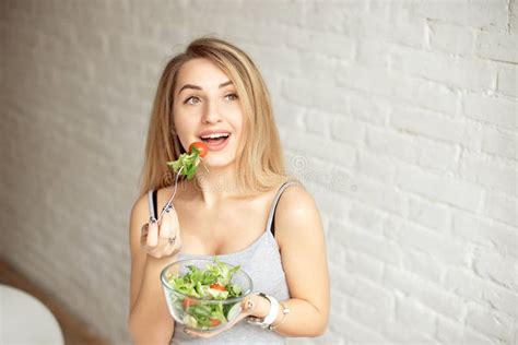 Attractive Happy Woman Holding Bowl Of Fresh Vegetable Salad In Hands