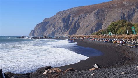 Kamari, Kamari, Greece - Black pebble beach in Santorini, Greece.