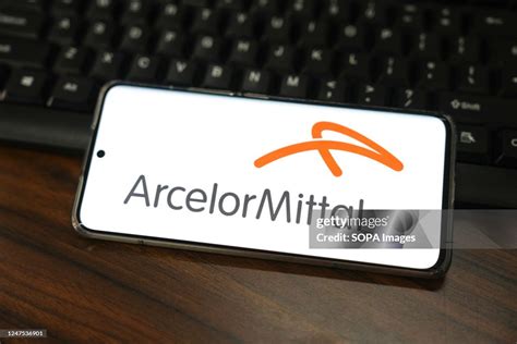 In this photo illustration, an ArcelorMittal logo seen displayed on a ...