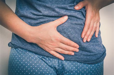 Woman With Stomach Pain Is Holding Her Aching Belly Stock Photo Image