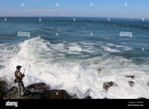 Fishing on rocks Stock Photo - Alamy